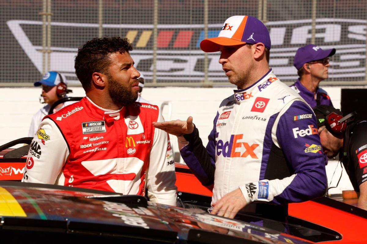 Bubba Wallace, driver of the No. 23 DoorDash Toyota, talks with co-team owner Denny Hamlin, driver of the No. 11 FedEx Express Toyota, after the last chance qualifying race for the NASCAR Cup Series Busch Light Clash at the Los Angeles Memorial Coliseum on Feb. 6, 2022 in Los Angeles.