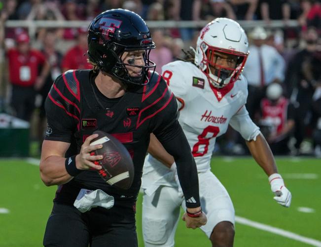 Texas Tech's Will Hammond rolls out for the pass against Houston during a Big 12 Conference football game, Friday, Sept. 18,
