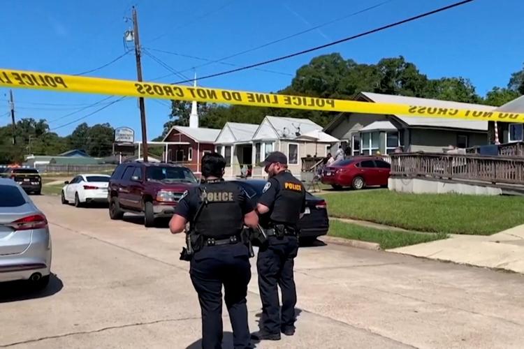 Police officers secure the scene where eight children were killed in a mass shooting in Shreveport