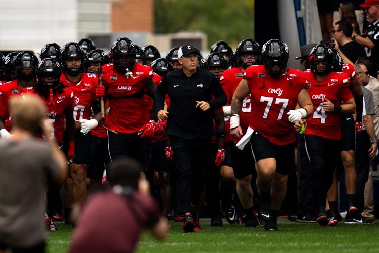 Cincinnati Bearcats head coach Scott Satterfield runs onto the field with the rest of the team before the football game between