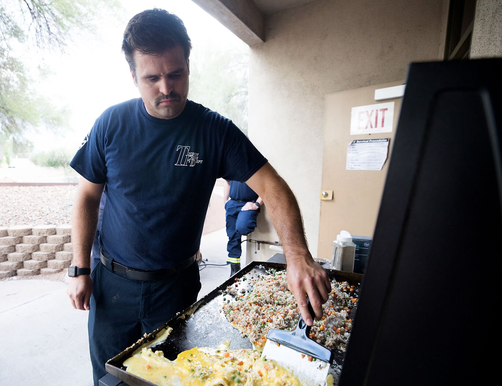 TFD paramedic Scott cooks over a grill