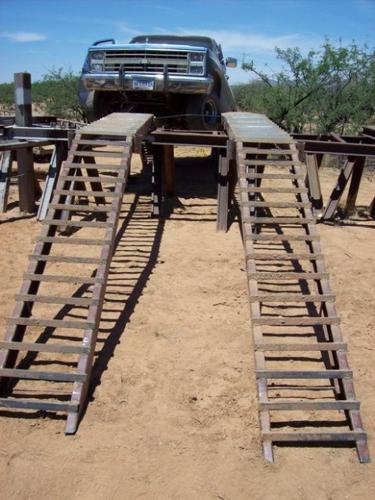 Dope smuggler's pickup gets stuck on homemade ramp over border fence  