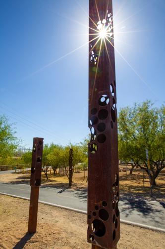 Sculpture along river park trail