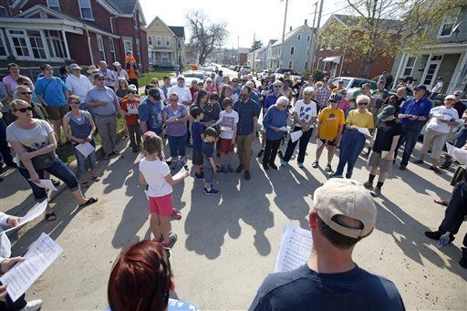 Dubuque residents gather to pray, sing at cross burning site