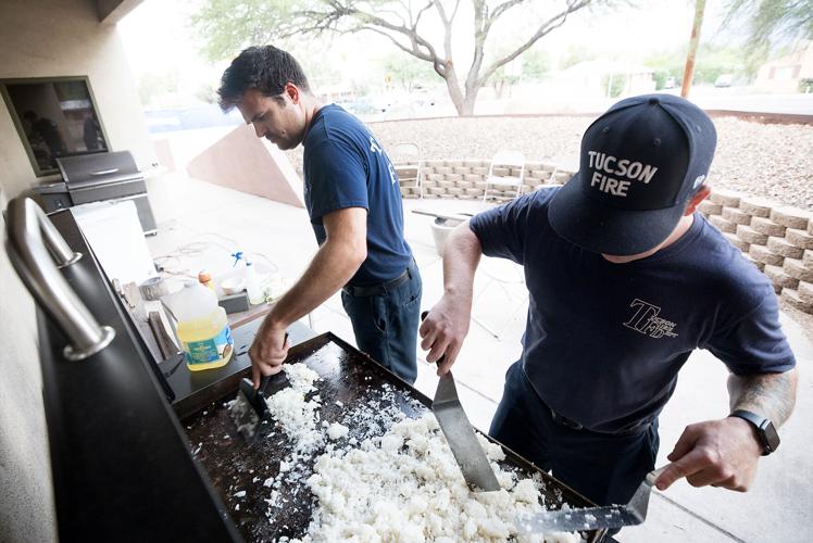 TFD firefighters Scott and Daniel cook on the grill outside Station 7