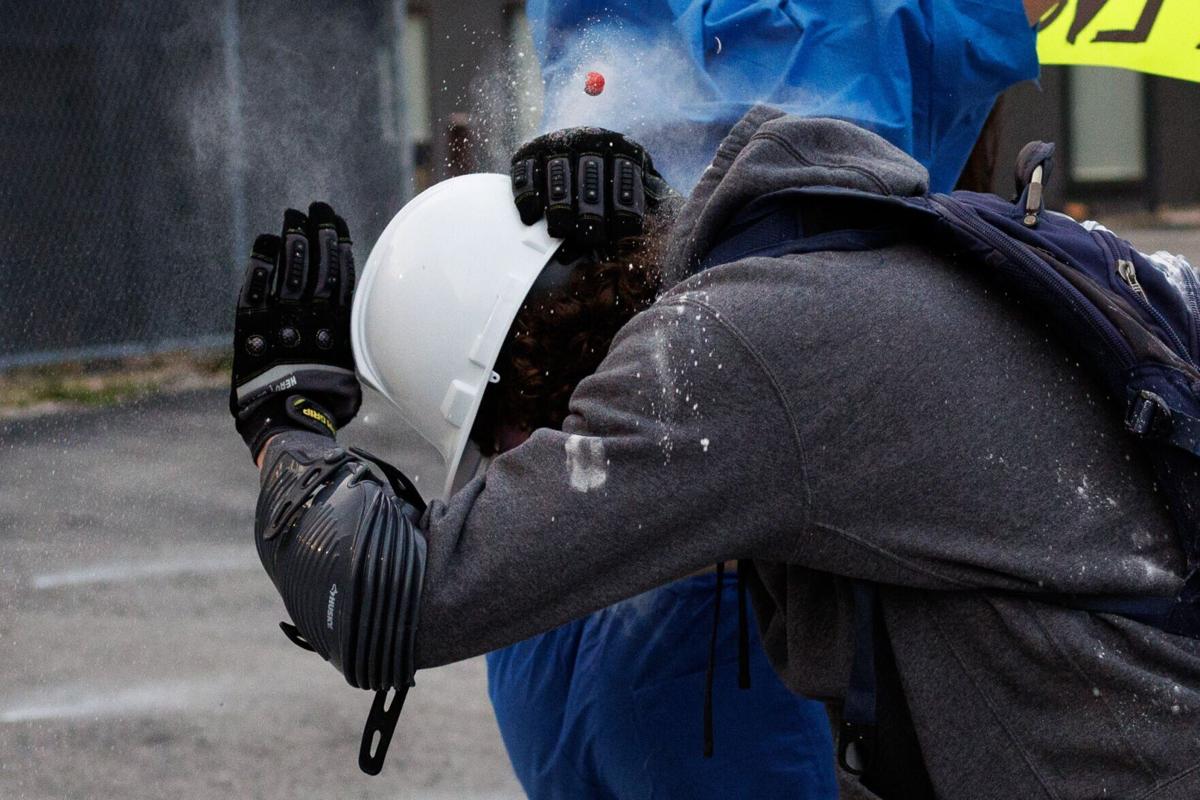 A protester is shot with paintball gun pepper ball outside the Immigration and Customs Enforcement building on Sept. 19, 2025, in Broadview.