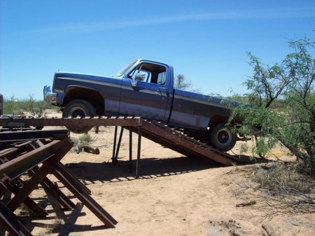 Dope smuggler's pickup gets stuck on homemade ramp over border fence  