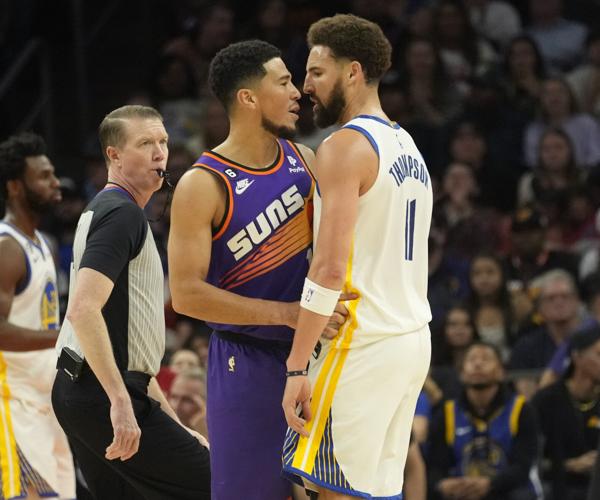 Phoenix Suns guard Devin Booker (1) and Golden State Warriors guard Klay Thompson (11) confront each other after a play during the third quarter at Footprint Center in Phoenix on Oct. 25, 2022. Thompson received two technicals and was ejected.