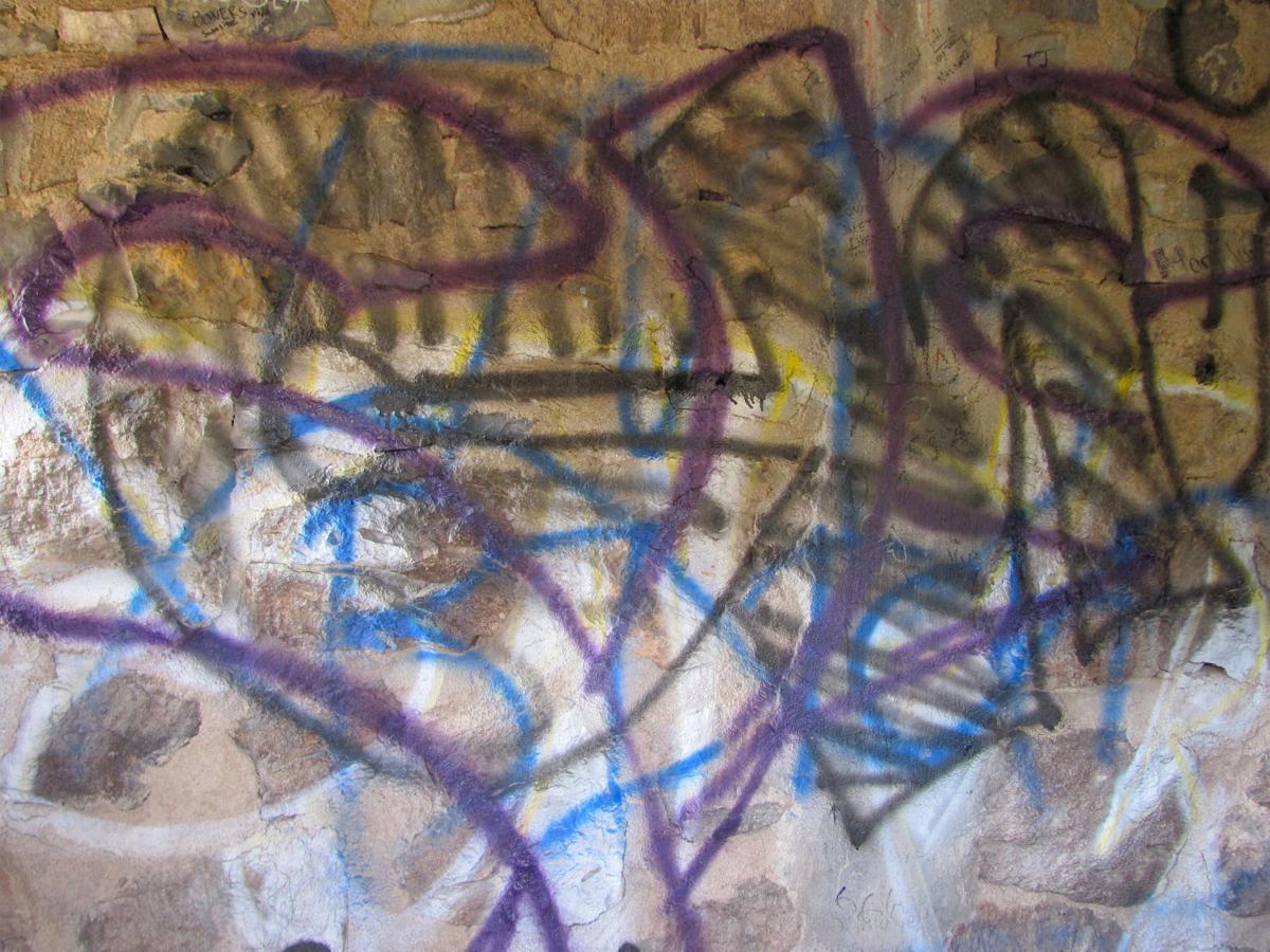 Vandals spraypaint graffiti on historic stone building west of Tucson