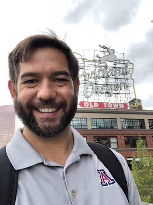 Eddie in front of The Stag Sign in Portland