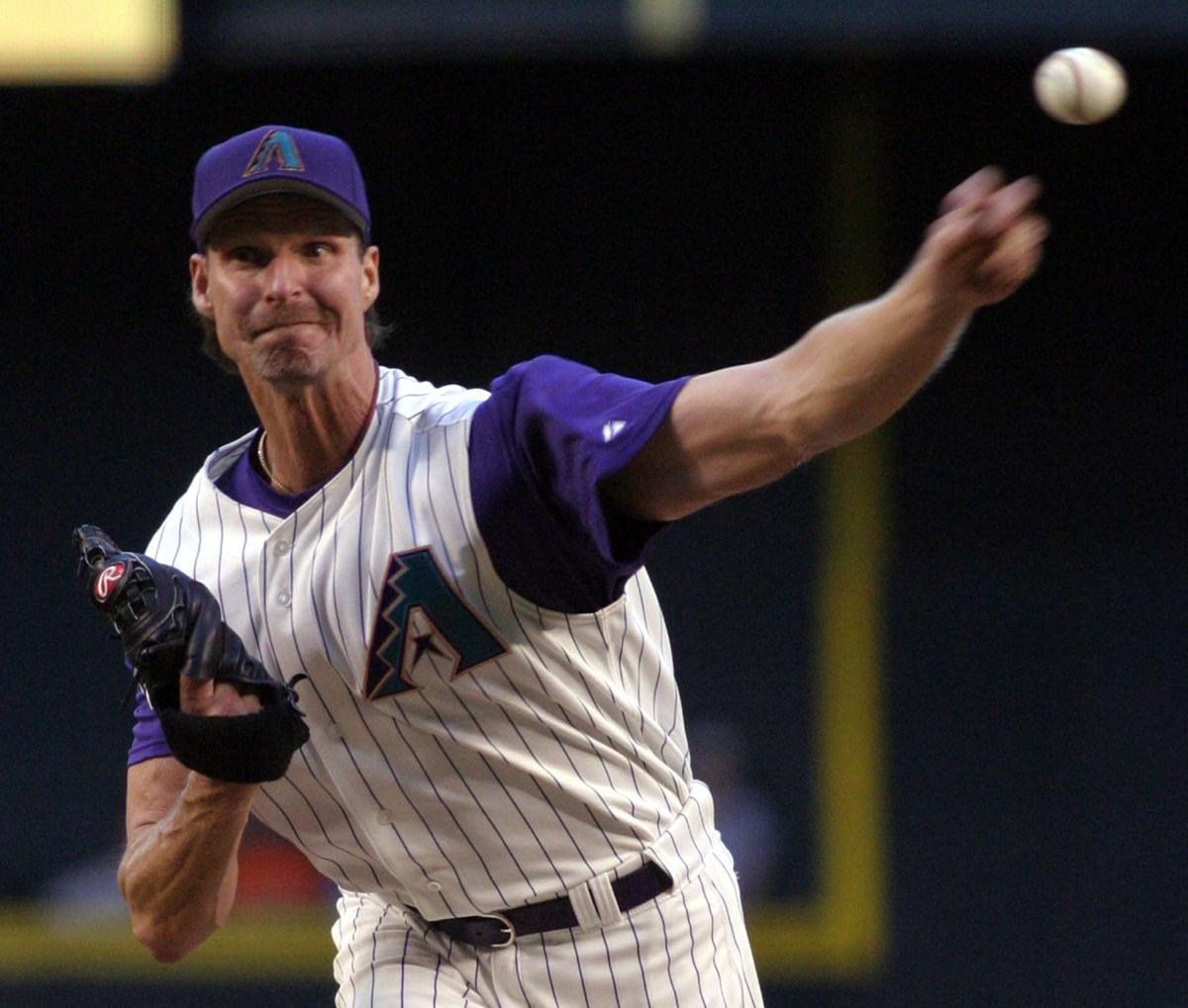 FILE - In this Nov. 3, 2001, file photo, Arizona Diamondbacks pitcher Randy  Johnson throws against the New York Yankees in the first inning of Game 6  of baseball's World Series at