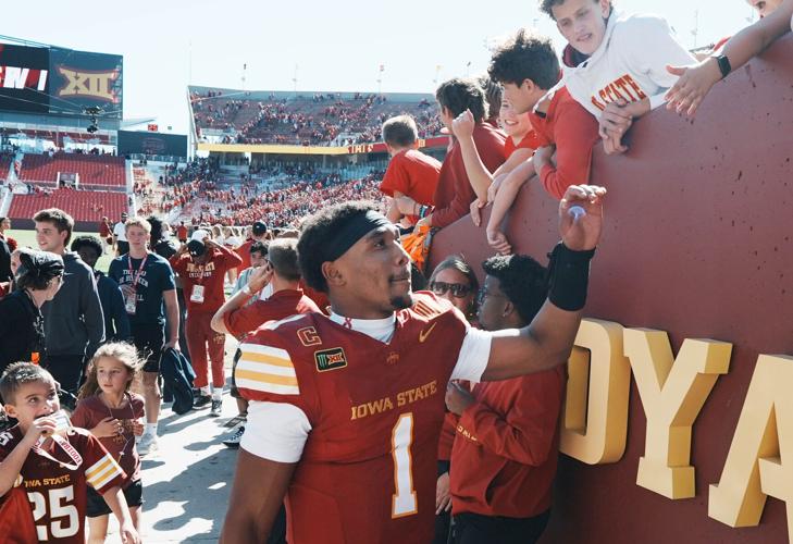 Iowa State quarterback Jaylen Raynor celebrates with fans after winning 45-42 over West Virginia during the fourth quarter