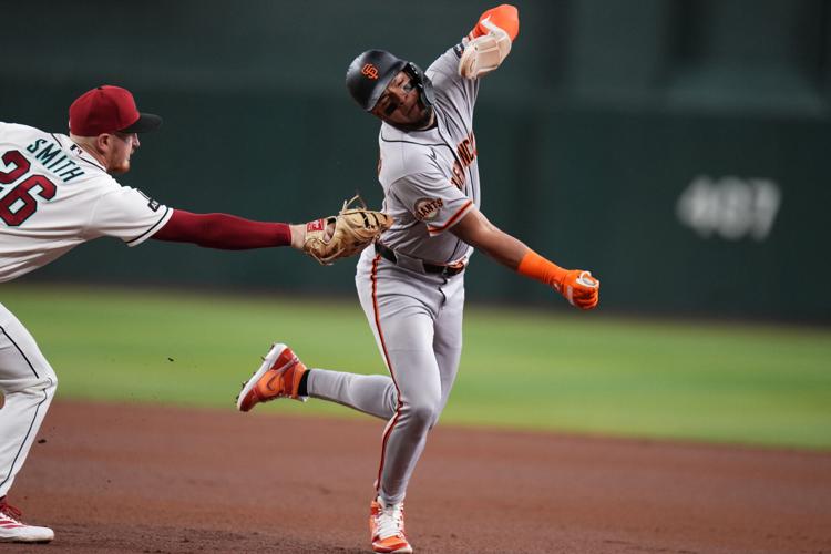 San Francisco Giants base runner Victor Bericoto (78) is tagged out by Arizona Diamondback infielder Pavin Smith (26) on June