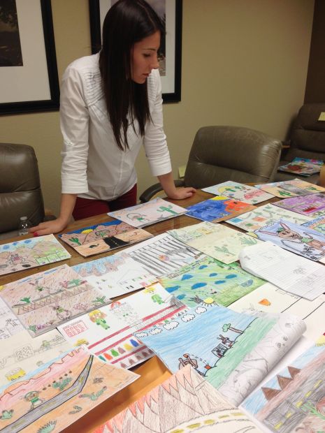 Glassmans giving book to Vail, TUSD kindergartners
