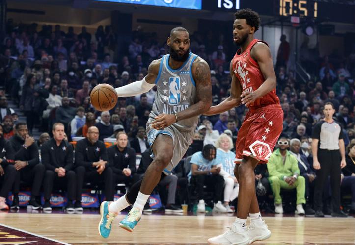 LeBron James of Team LeBron dribbles the ball around Andrew Wiggins of Team Durant in the first half during the 2022 NBA All-Star Game at Rocket Mortgage Fieldhouse on Sunday, Feb. 20, 2022, in Cleveland.