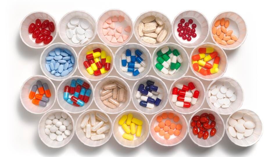 Lots of different prescription drugs in small cups