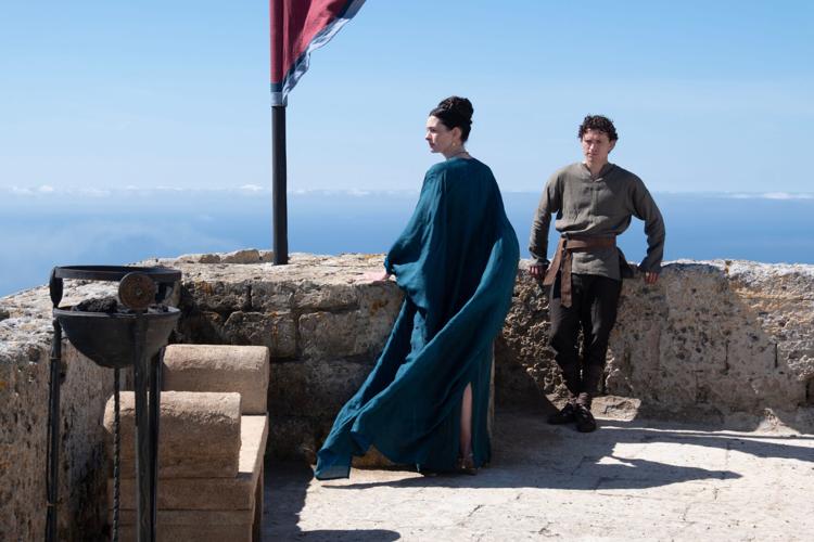 Penelope (Anne Hathaway, left) and Telemachus (Tom Holland) are left in charge of a crumbling castle as devious suitors wear their last nerves.