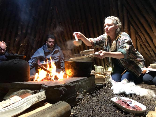 Anki Vinka serves lunch inside a traditional Sami tepee-like structure called a goathie.