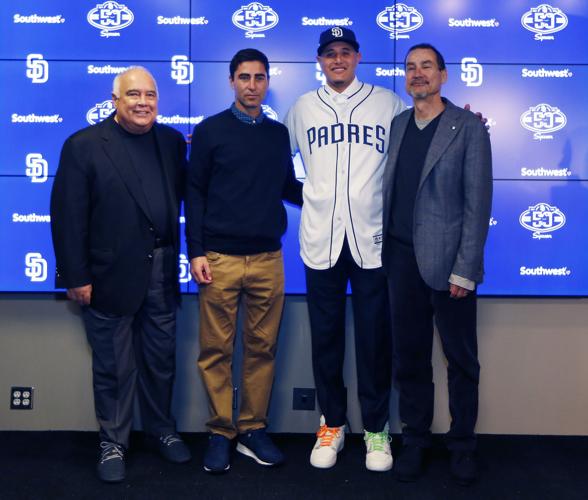 From left, San Diego Padres executive chairman Ron Fowler, general manager A.J. Preller, infielder Manny Machado and general partner Peter Seidler take a photo after a news conference on Friday, Feb. 22, 2019, in Peoria, Ariz. Machado agreed to a 10-year, $300 million contract with the Padres.