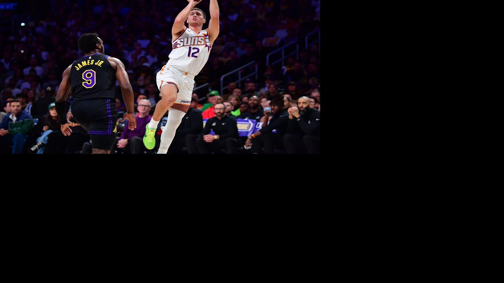 Phoenix Suns guard Collin Gillespie (12) shoots against Los Angeles Lakers guard Bronny James (9) during the first half at Crypto Arena in Los Angeles, on April 10, 2026.