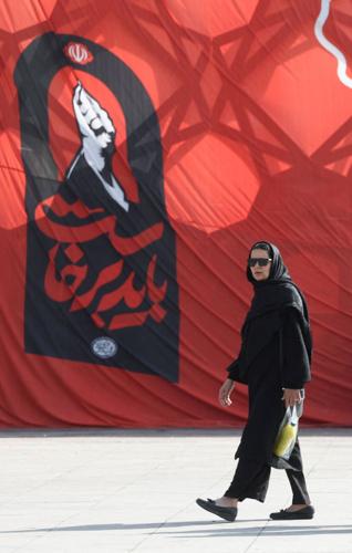 People walk at Imam Hussein Square in Tehran