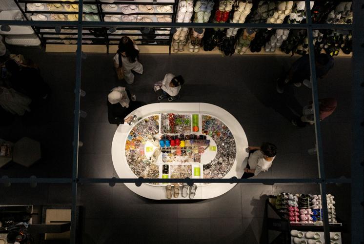 People gather in the Crocs store in a shopping mall in Beijing