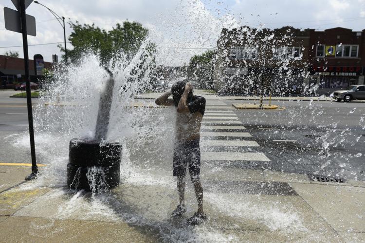 A person cools off with water from an open fire hydrant during a heat wave on the West Side of Chicago, Illinois, on July 2, 2026. Blistering temperatures and humidity gripped swaths of the United States on July 1, with the worst yet to come for the densely populated East Coast as the nation co-hosts the World Cup and prepares to celebrate its 250th birthday.