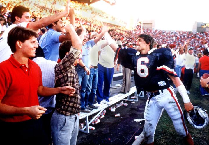 Chuck Cecil celebrates with fans