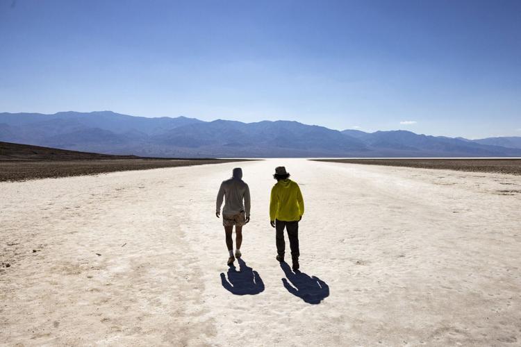 Visitors walk under the sun at Badwater Basin in Death Valley National Park, near Furnace Creek, during a heatwave impacting Southern California on July 7, 2024.