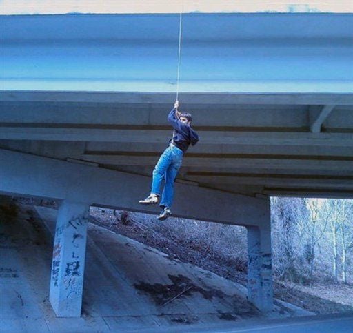 Amorous teen caught hanging from bridge in graffiti attempt