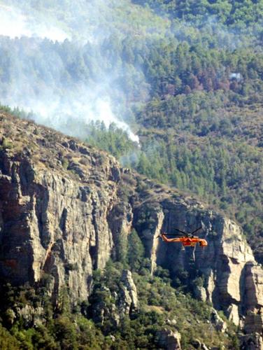 Tamer winds let firefighters make progress, provide hope   