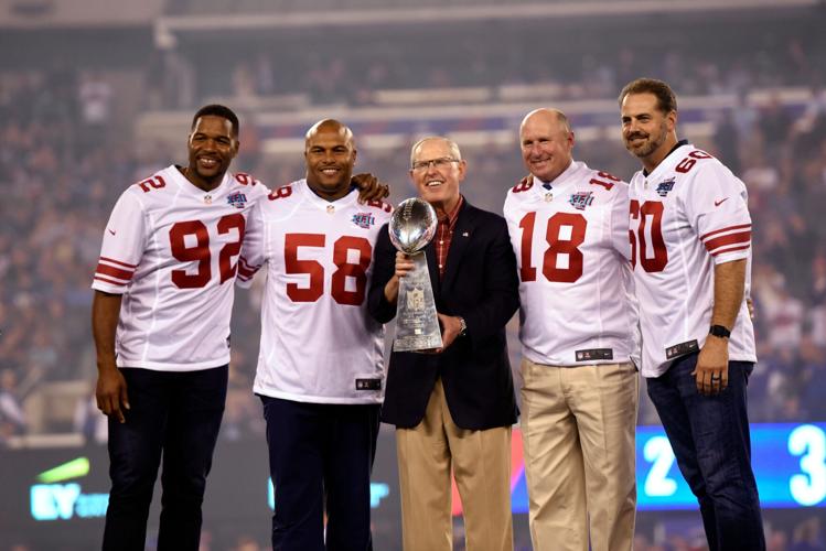 Representing the New York Giants team that won the 2007-season Super Bowl XLII are, from left, Michael Strahan, Antonio Pierce, head coach Tom Coughlin, Jeff Feagles, and Shaun O'Hara, standing on the stage during a ceremony as the Giants played the Detroit Lions in their home opener on Monday, September 18, 2017, in East Rutherford.