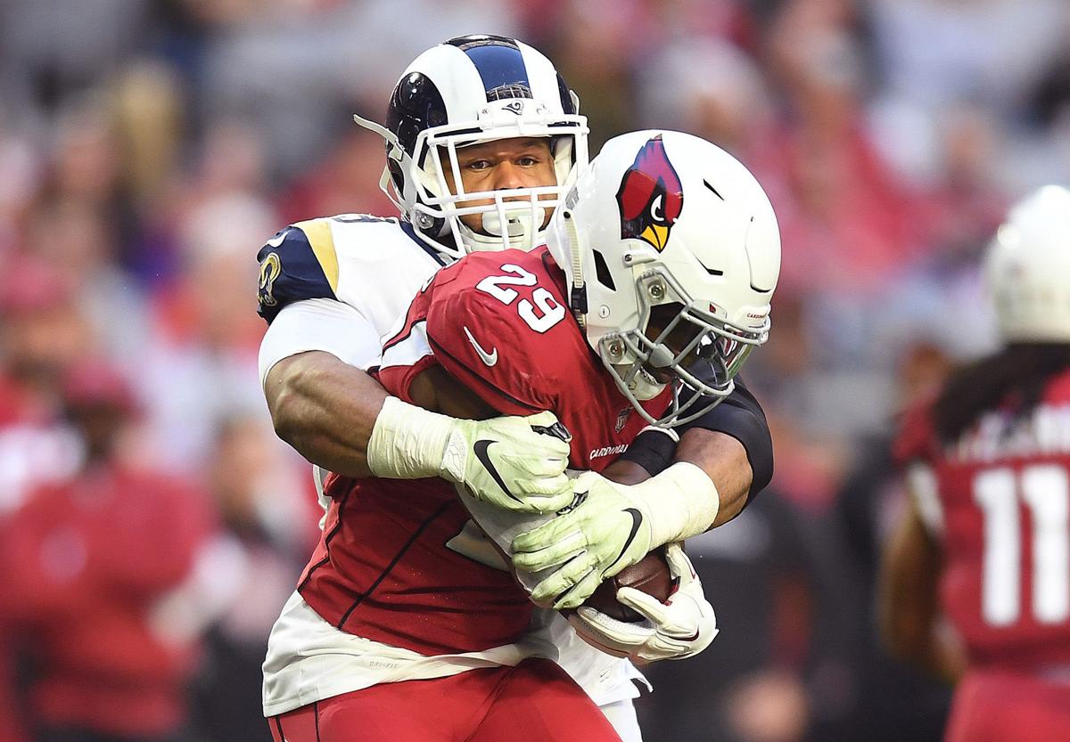 Los Angeles Rams defensive tackle Aaron Donald tackles Arizona Cardinals running back Chase Edmonds for a loss in the second quarter on Sunday, Dec. 23, 2018 at State Farm Stadium in Phoenix, Ariz.