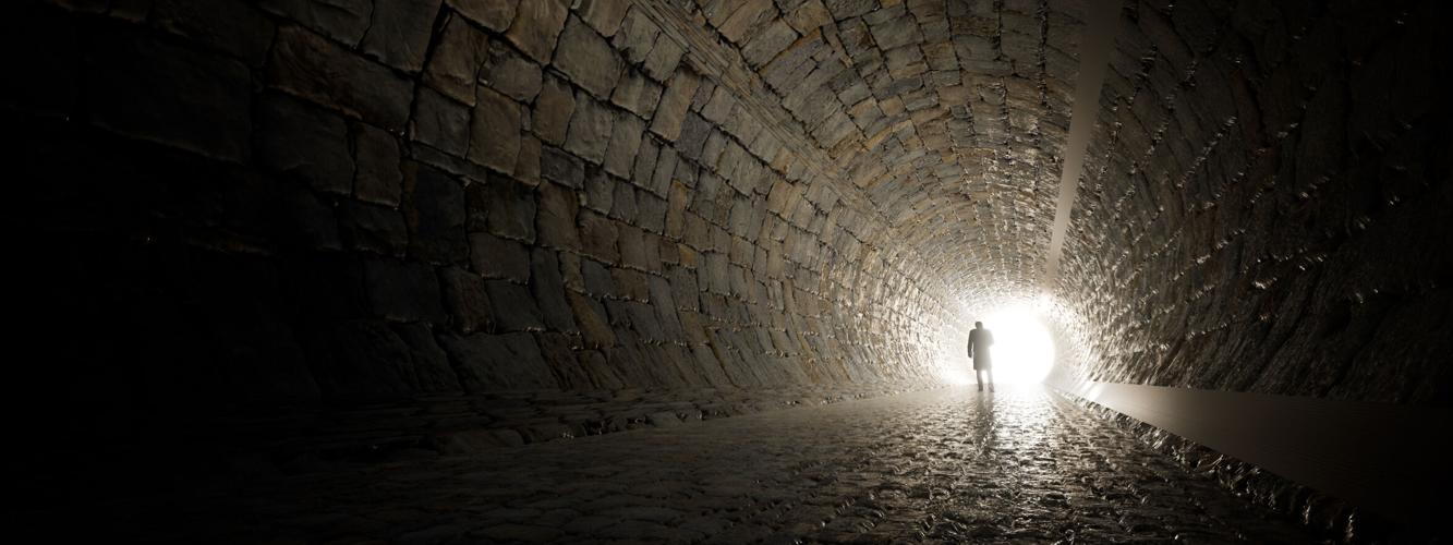Concept or conceptual dark tunnel with a bright light at the end or exit as metaphor to success, faith, future or hope to new opportunity or freedom 3d illustration