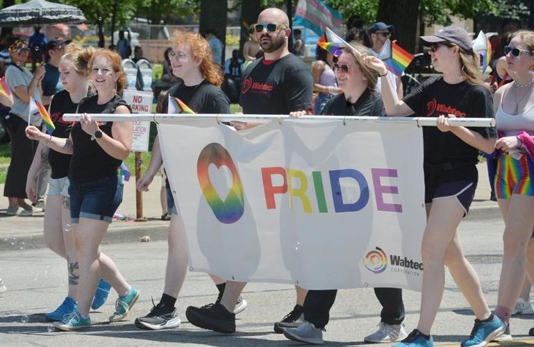 Participants walk in the Erie Pride Parade, sponsored by the Northwestern Pennsylvania Pride Alliance, north along State Street from West 11th Street to Perry Square in Erie on June 29, 2025.