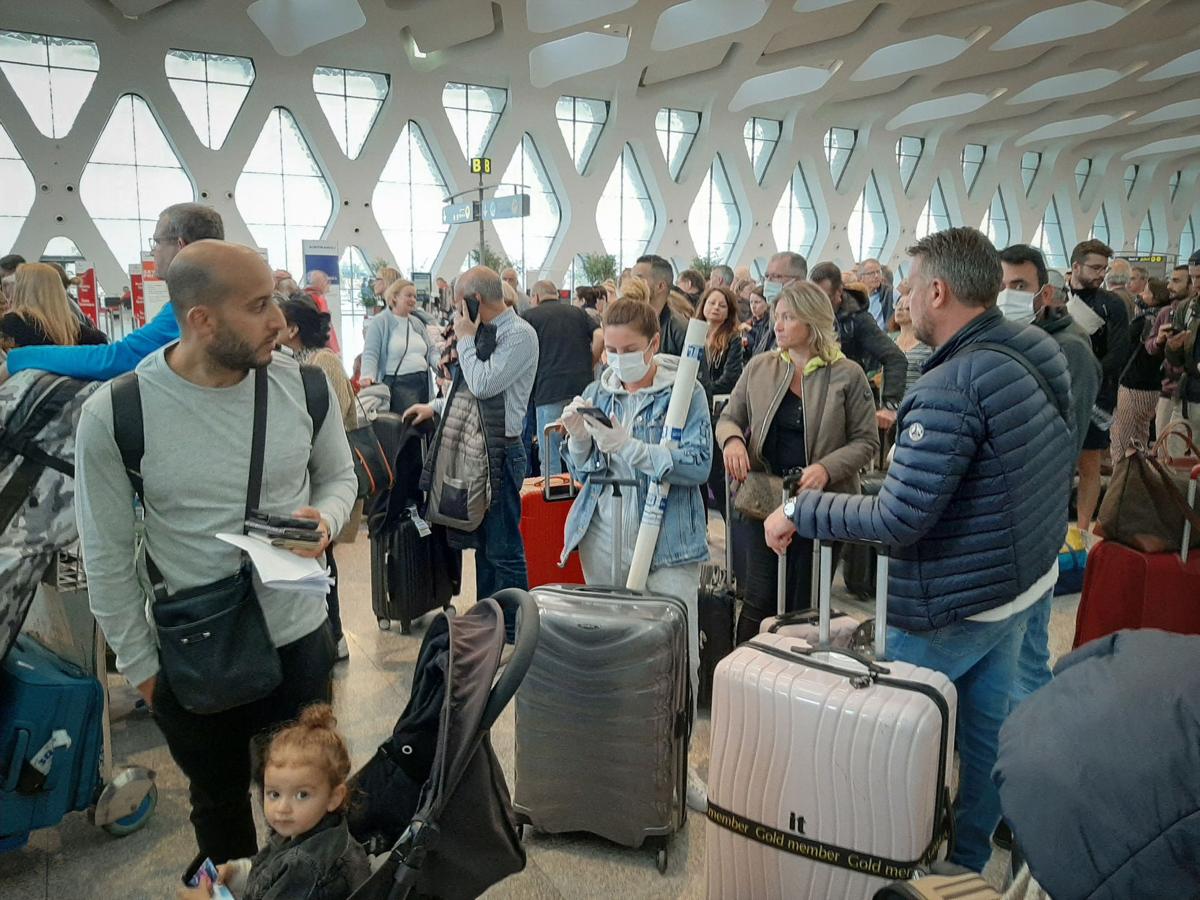 Passengers wait for their flights at the Marrakesh Airport on March 15, 2020. Several special flights departed Morocco, taking thousands of stranded Europeans home as the kingdom announced it was suspending all regular air traffic due to the coronavirus, authorities and airports said.