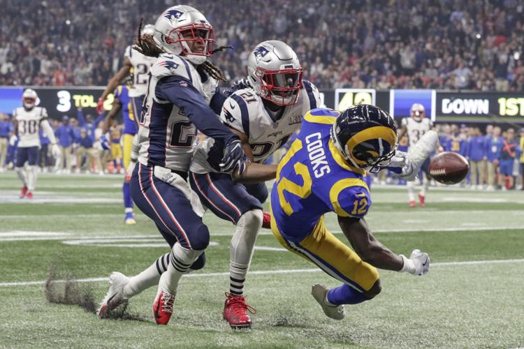 Los Angeles Rams receiver Brandin Cooks (12) misses a potential touchdown pass, broken up by New England Patriots defenders Stephon Gilmore (24) and Duron Harmon (21) during the fourth quarter in Super Bowl LIII at Mercedes-Benz Stadium in Atlanta on Sunday, Feb. 3, 2019. The Patriots won, 13-3. (Robert Gauthier/Los Angeles Times/TNS