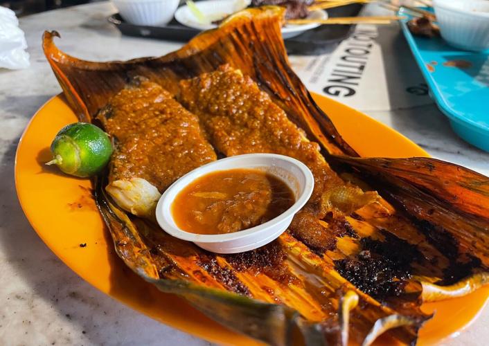 Real specialities: Many stalls at Singapore's Lau Pau Sat specialise in grilled stingray wrapped in banana leaves.
