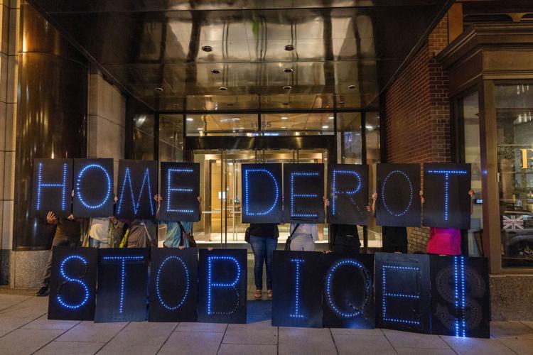 Washington, D.C., community members hold signs calling on Home Depot to stop helping ICE in its area stores on Sept. 3, 2025, in Washington, D.C..