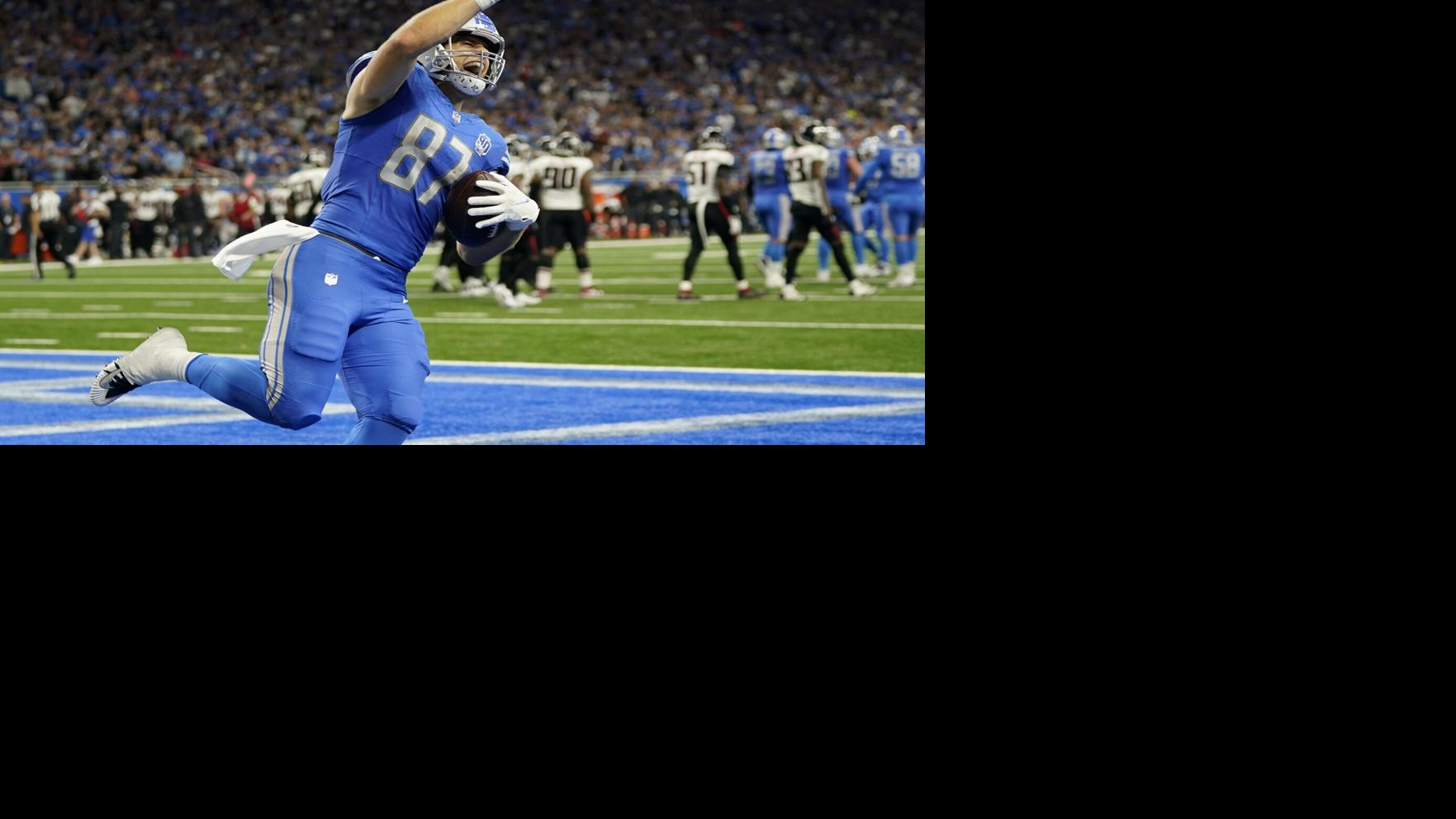 Detroit Lions players shake hands with fans after they defeated