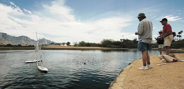 Sailboats race across a pond  