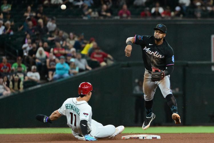 Miami Marlins shortstop Otto Lopez turns a double play on Arizona Diamondbacks pinch hitter Jose Fernandez (11) in the sixth inning at Chase Field on Sept. 16, 2026.