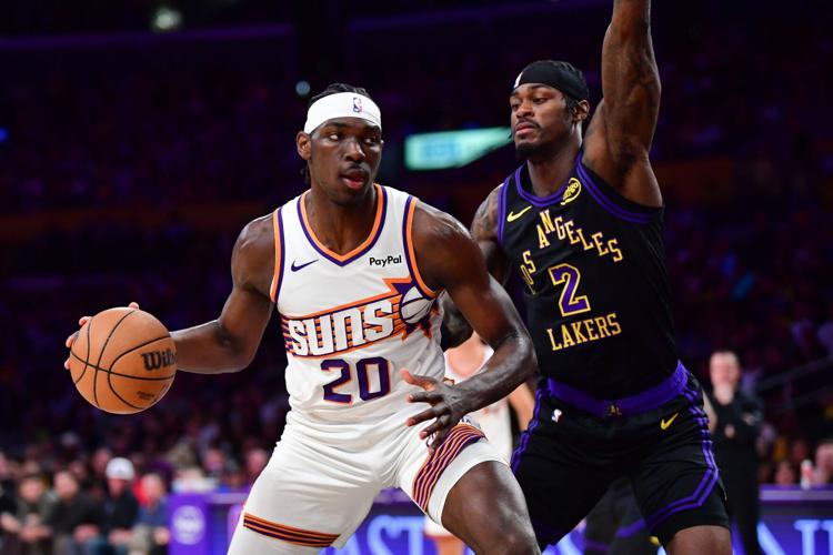 Phoenix Suns forward Rasheer Fleming (20) moves the ball against Los Angeles Lakers forward Jarred Vanderbilt (2) during the first half at Crypto.com Arena in Los Angeles, on April 10, 2026.