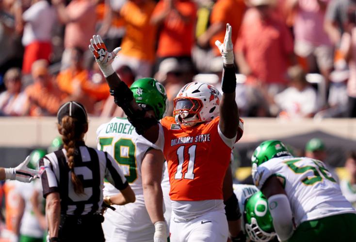 Oklahoma State's Keviyan Huddleston (11) celebrates a play in the second half of the college football game between the Oklahoma