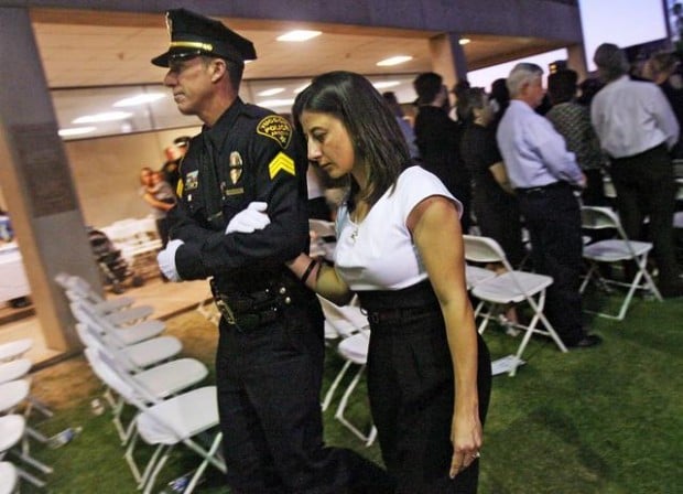 Grief comes to surface at tribute for slain police