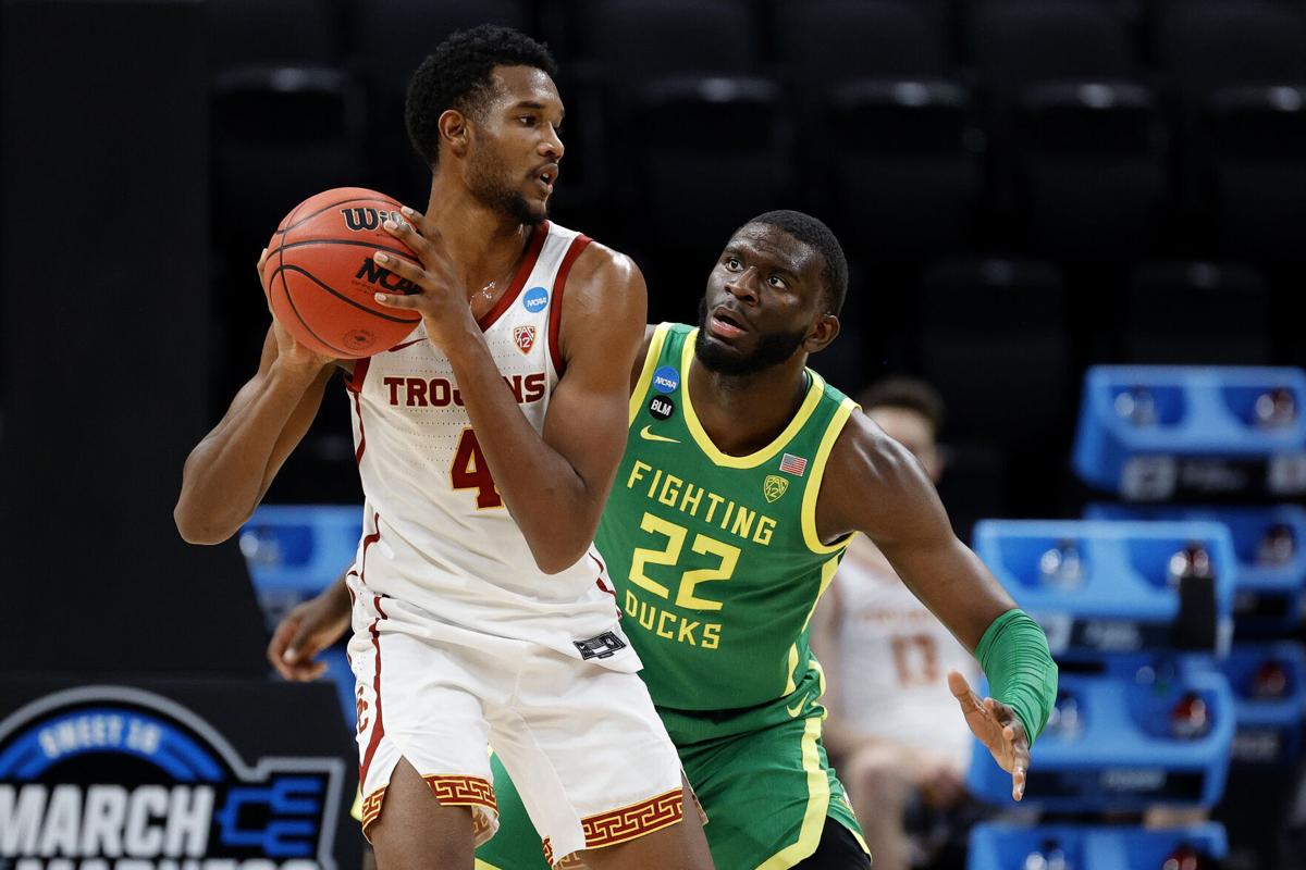 Evan Mobley #4 of the USC Trojans looks to pass against Franck Kepnang #22 of the Oregon Ducks in the second half of their Sweet Sixteen round game of the 2021 NCAA Men's Basketball Tournament at Bankers Life Fieldhouse on March 28, 2021, in Indianapolis, Indiana.