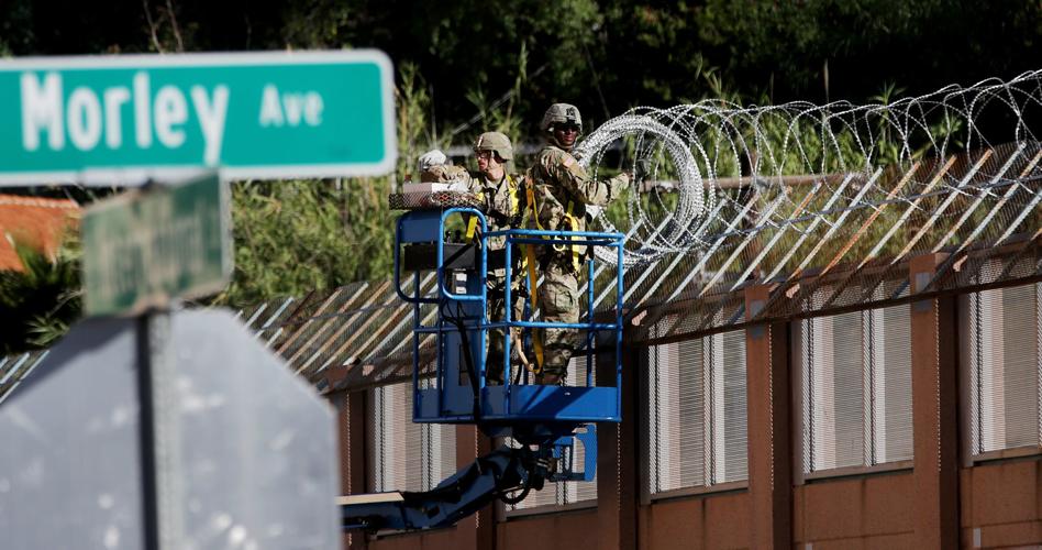 Troops install concertina wire at border fence