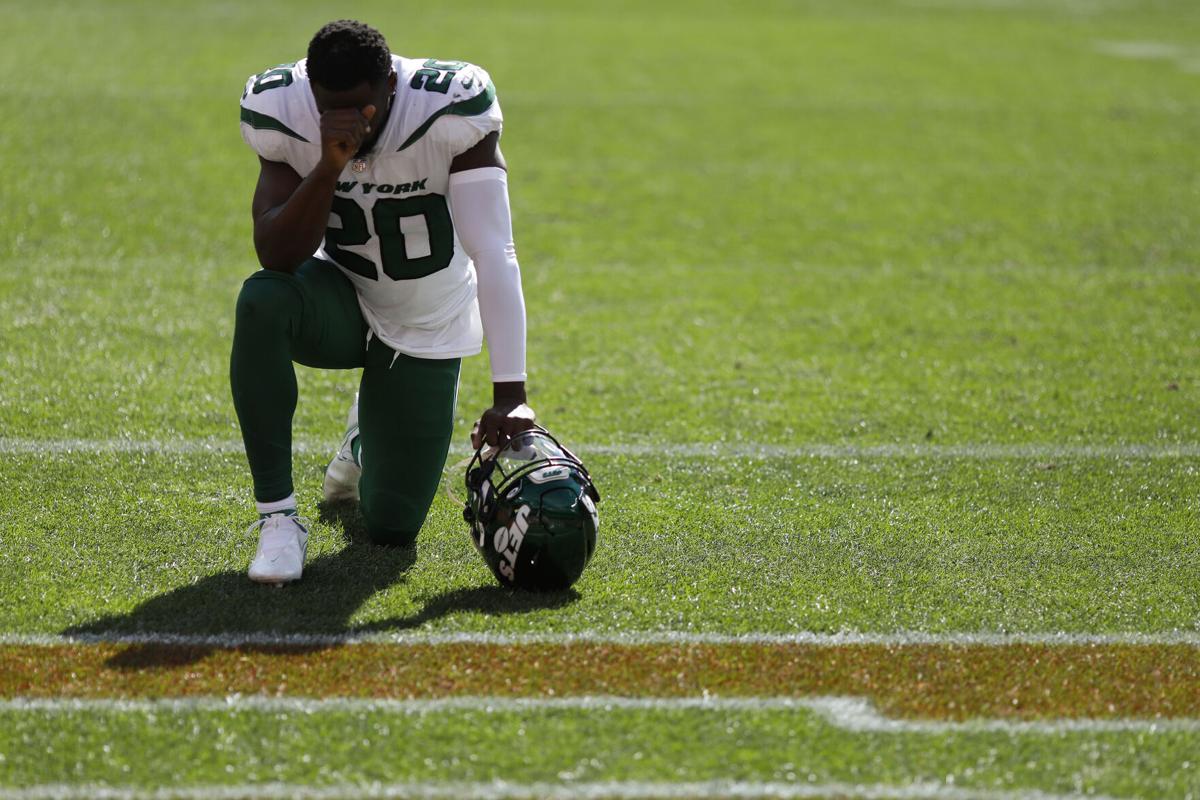 In this photo from September 26, 2021, Marcus Maye of the New York Jets takes a knee before the game against the Denver Broncos at Empower Field At Mile High in Denver, Colorado.