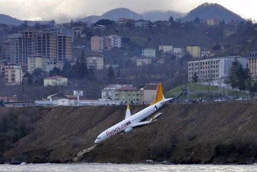 Plane dangles off cliff after skidding off runway in Turkey