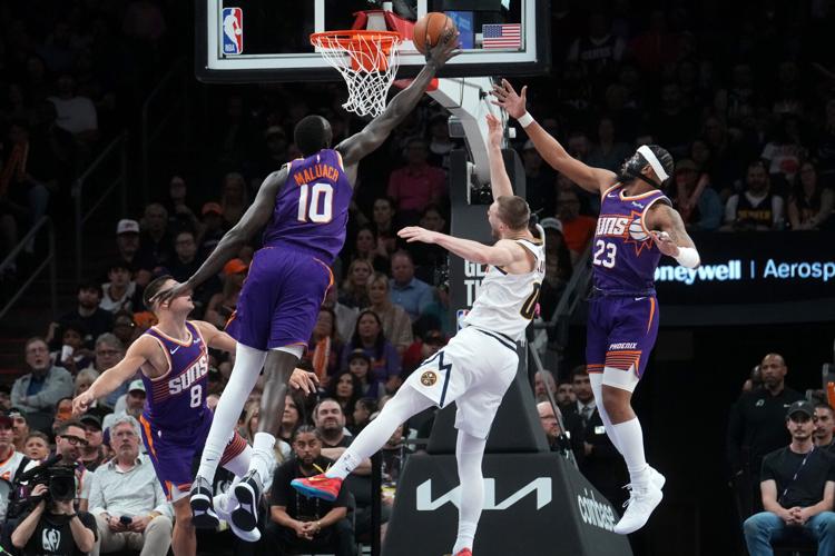 Phoenix Suns center Khaman Maluach (10) blocks a shot by Denver Nuggets guard Christian Braun (0) at Mortgage Matchup Center on March 24, 2026.